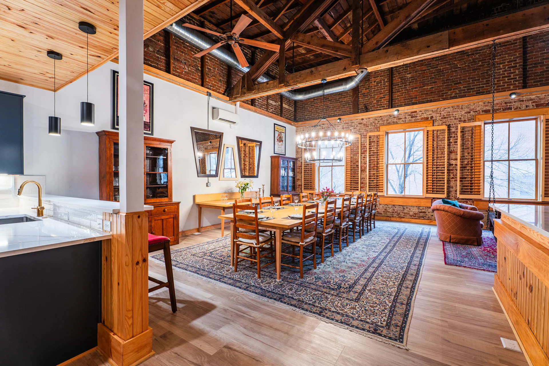 Grand dining hall with exposed brick walls and original wooden rafters