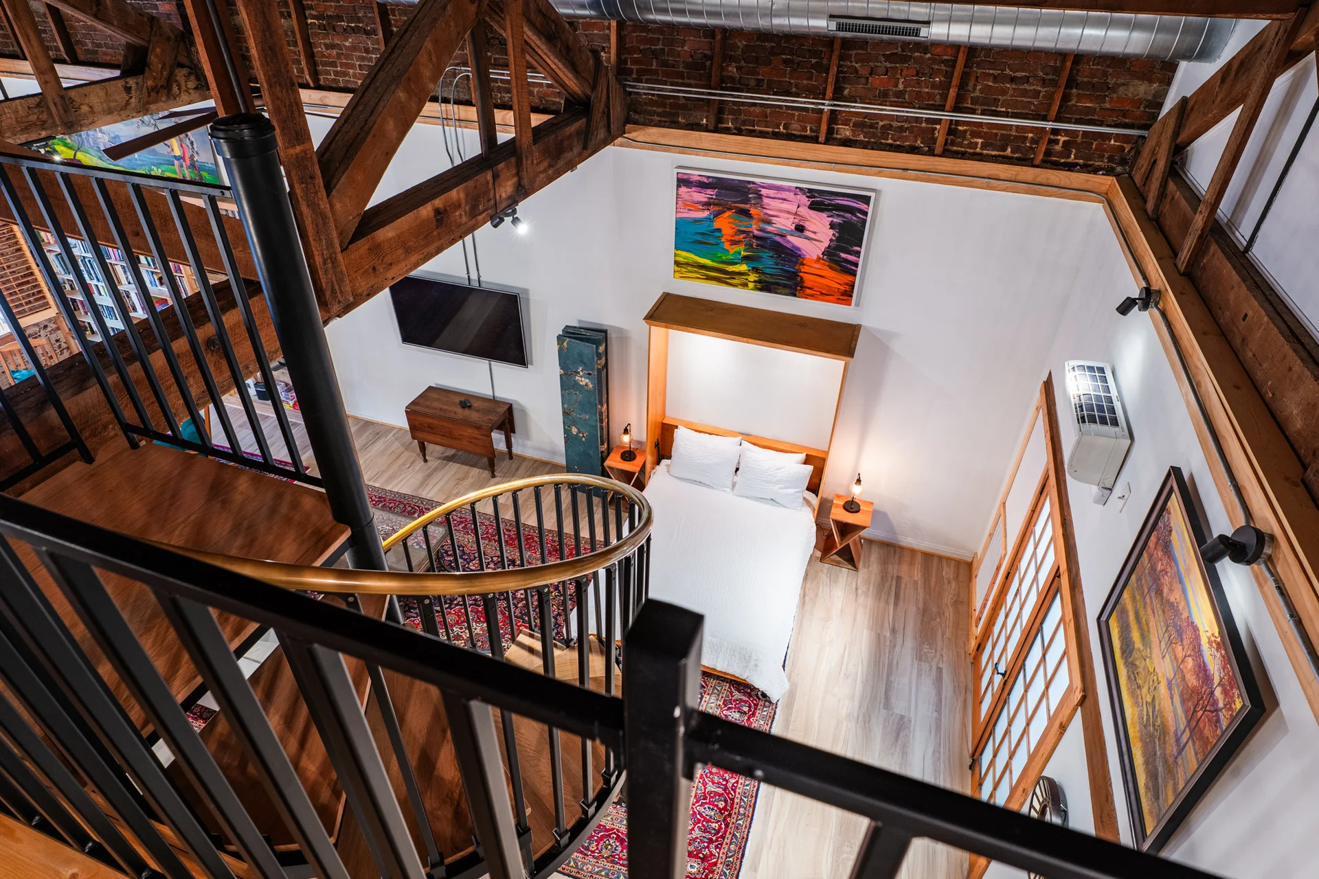 Mezzanine bedroom with queen bed and exposed beams